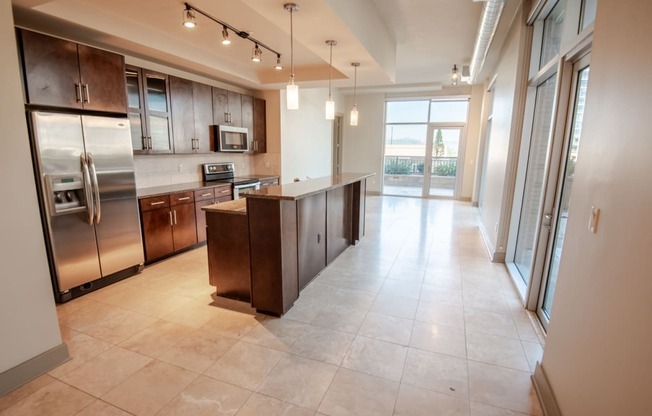 a kitchen with an island and stainless steel appliances