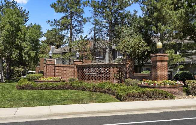 the front of a brick building with a sign that reads at Verona, Littleton, CO, 80123