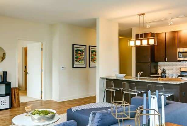 a living room with a blue couch and a table