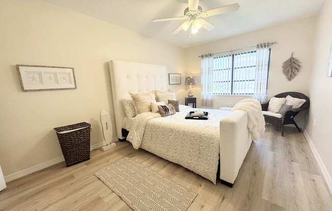 a bedroom with a bed and a ceiling fan