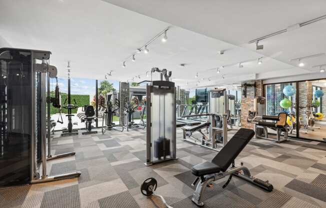 Fitness center with weights, cardio machines and cable weight machines at Bay Village 1 in Palmetto Bay, FL