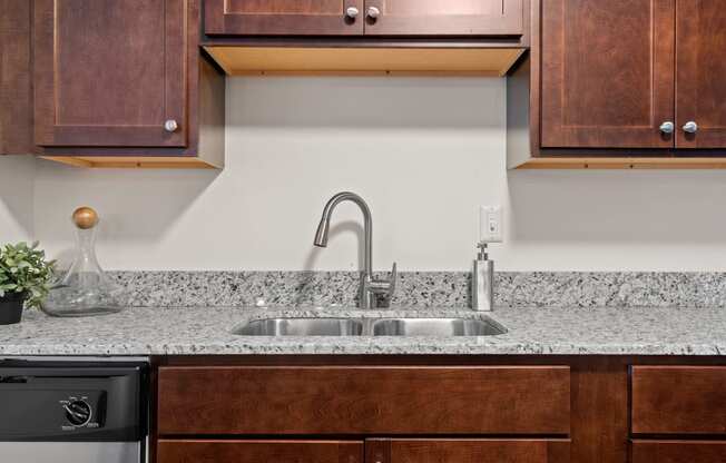 Kitchen with Dark Brown Cabinetry and Stainless Steel Appliances