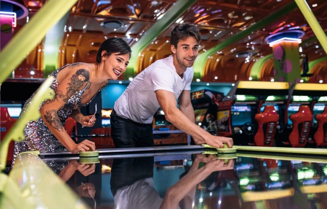a man and a woman playing bowling in a bowling alley