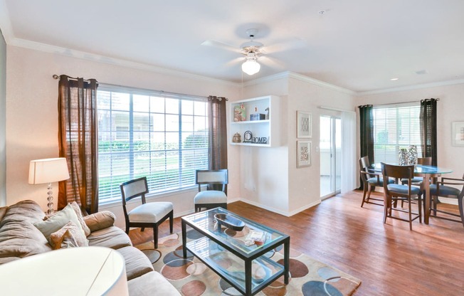 Open floor plan with glass doors to patio at Turnberry Isle Apartments in Far North Dallas, TX, For Rent. Now leasing 1, 2 and 3 bedroom apartments.