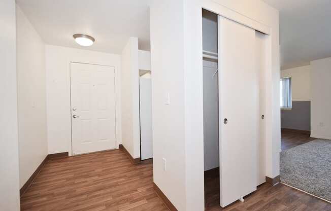 a bedroom with a medium hardwood floor and white walls