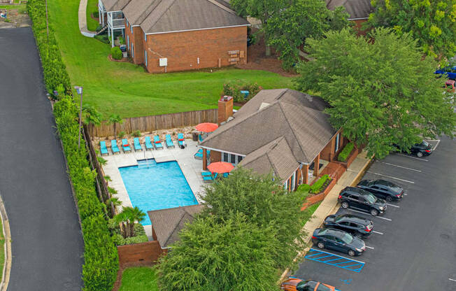 a house with a swimming pool and a parking lot