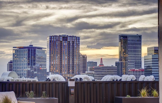 a view of the city skyline from a rooftop bar