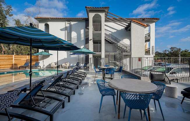 A patio with tables and chairs and a building in the background.