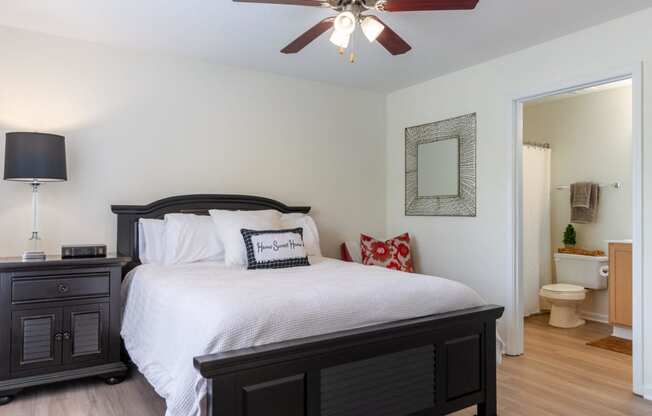 a bedroom with a large bed and a ceiling fan