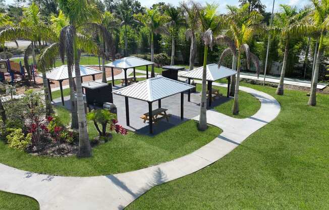 a park with picnic tables and palm trees