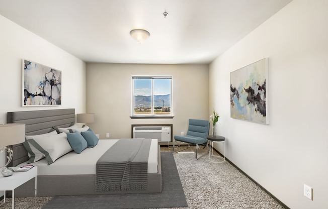 a bedroom with a bed and a chair in a 555 waverly unit  at Altitude, East Wenatchee