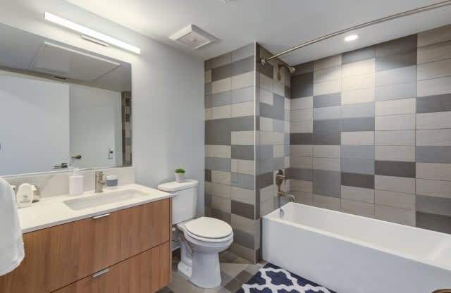 A bathroom with a white toilet, sink, and bathtub.