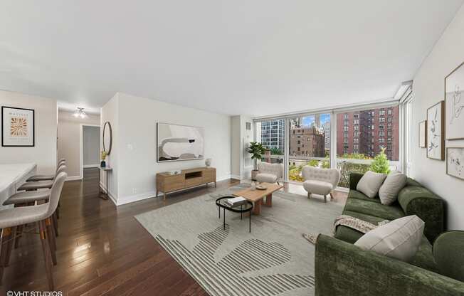 a living room with a green couch and a large window