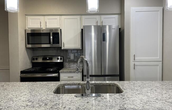 a stove top oven sitting inside of a kitchen