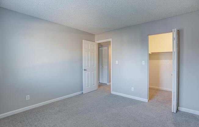 A room with a carpeted floor and white walls.