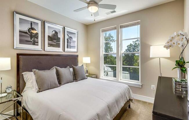 a bedroom with a bed and a ceiling fan