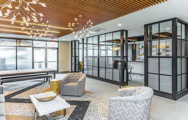 A modern living room with a wooden ceiling and glass walls.