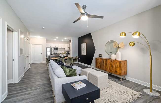 a living room with a white couch and a ceiling fan