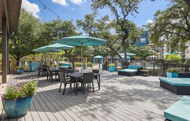 a patio with tables and chairs and umbrellas