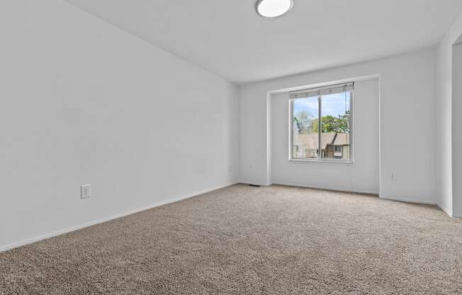 an empty room with carpet and a window at Edge At Farmington Hills - Farmington Hills, MI, Michigan