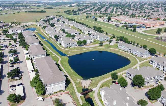 A bird's eye view of a residential area with a large lake in the middle.
