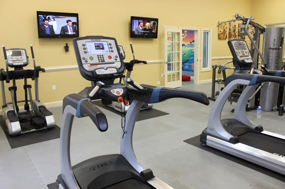 Fitness center with cardio equipment; flat screen TV