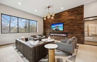 a living room with couches and chairs and a fireplace