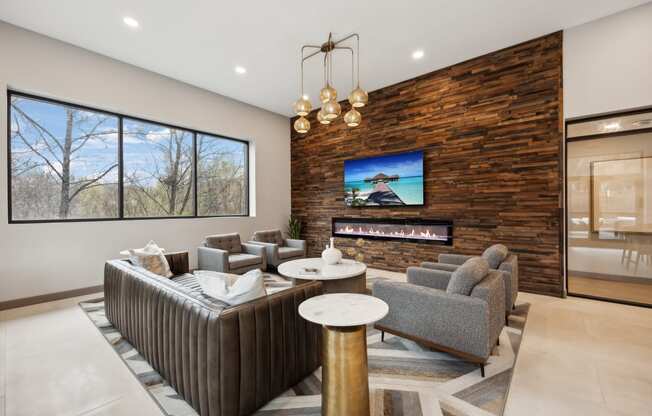 a living room with couches and chairs and a fireplace