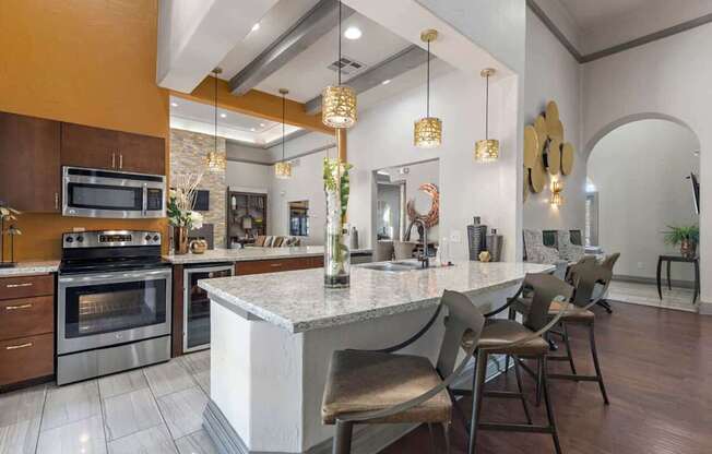 A modern kitchen with a large island and chairs at Reserve at Canyon Creek,San Antonio