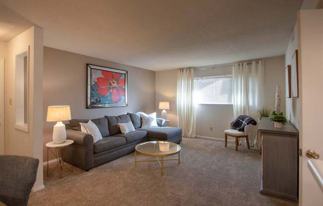 This is a photo of the living room in the 822 square foot, 2 bedroom, 1 bath floor plan at Village East Apartments in Franklin, OH.