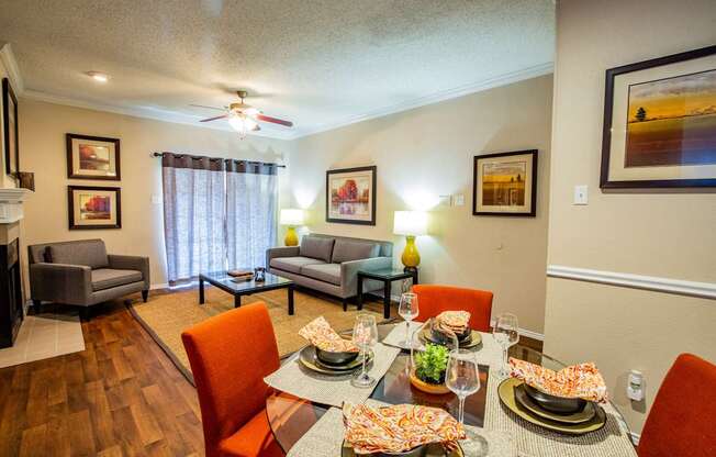 A dining room with a table set for a meal.