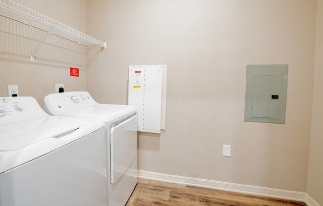 Room with a washer and dryer at Trillium apartments