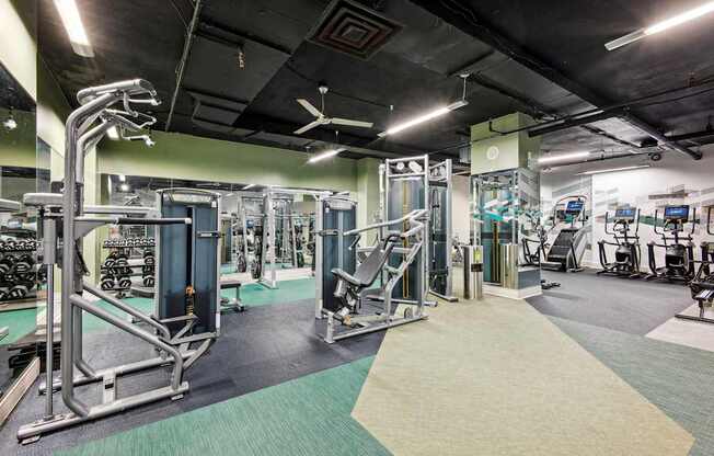 A gym with a variety of equipment including a leg press machine.