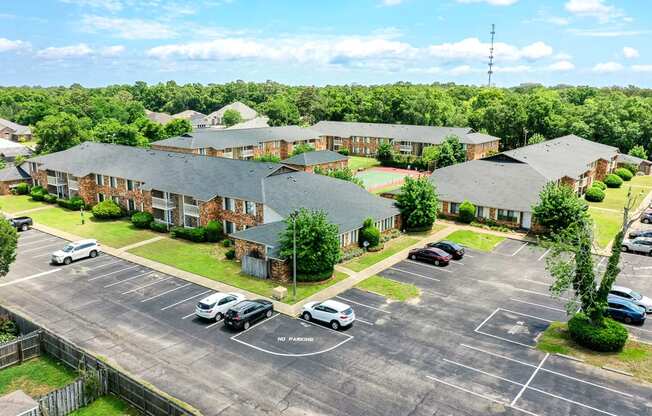 A parking lot with cars and a building in the background.