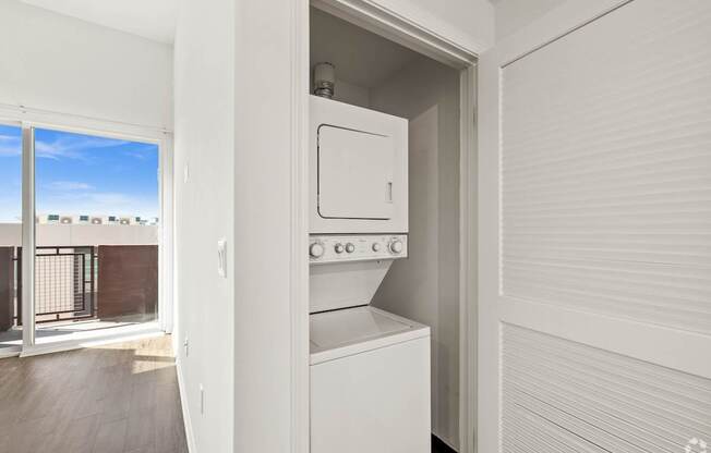 A white oven and microwave are built into a kitchen cabinet.