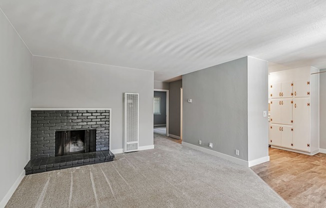 A room with a fireplace and a carpet.