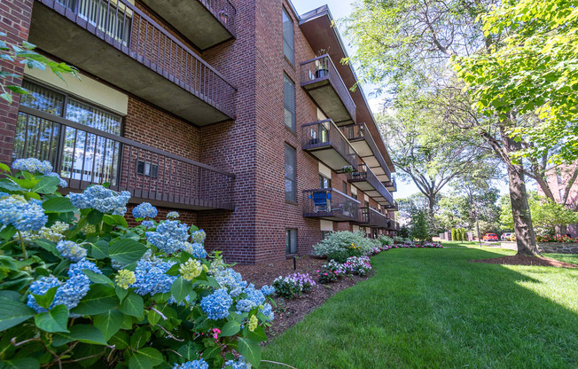 Quincy Commons apartments with beautiful landscaping and flowers along each building