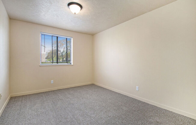 bedroom with carpet and a window at Old Farm Apartments, Elkhart, Indiana