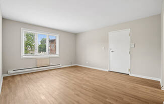 A living room with a window and a door.