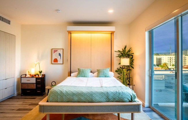 a bedroom with a bed and a sliding glass door