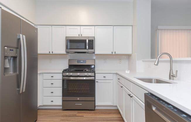 a kitchen with stainless steel appliances and wooden cabinets