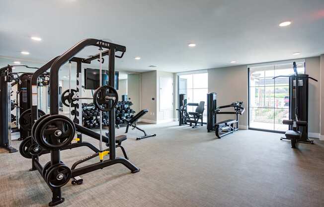 A well-equipped gym with a variety of machines and weights at Pradera Apartments, San Ramon, 94582