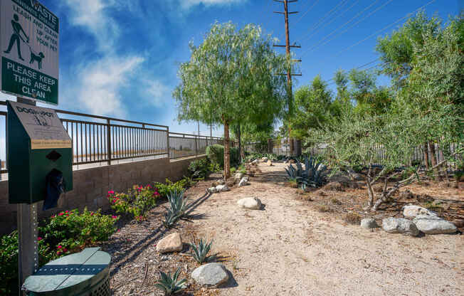 a trail with rocks and trees on the side of a bridge