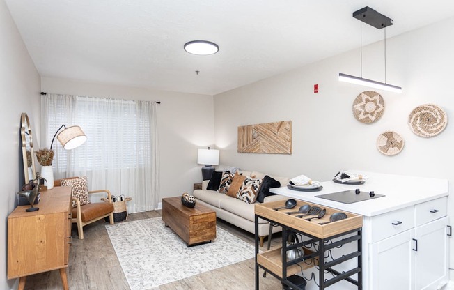 a living room with a kitchen and a dining table