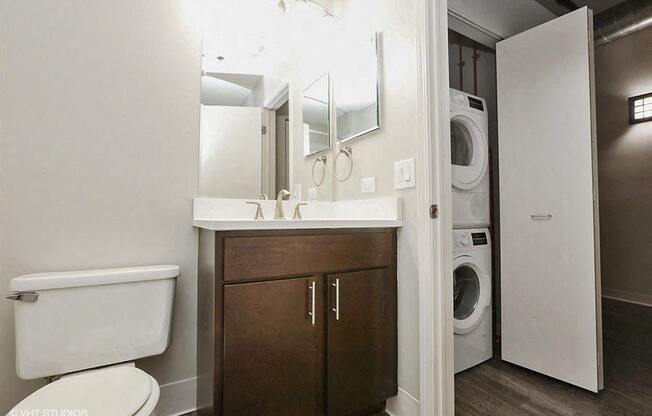 Bright bathrooms space with a stackable washer and dryerat Carriage House Lofts, Chicago, Illinois