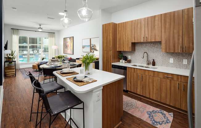 a kitchen and living room with a white counter top