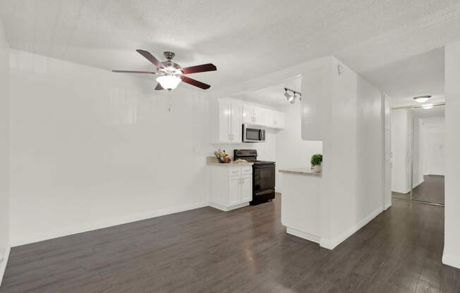 a living room and kitchen with a ceiling fan at Willow Tree Apartments, Torrance, CA, 90505