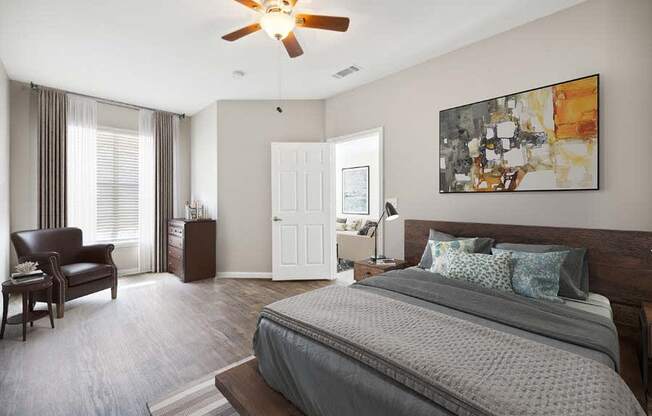 a bedroom with a large bed and a ceiling fan