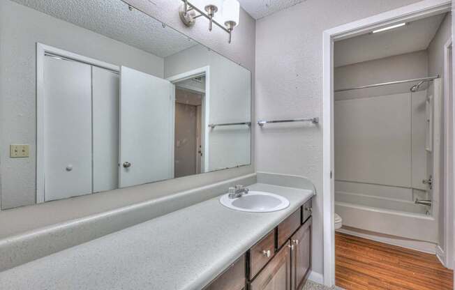 A bathroom with a sink, mirror, and shower at Landmark at Lyncrest Reserve Apartments, Tennessee 37209