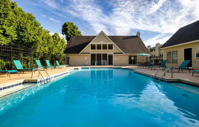 a swimming pool with a house in the background